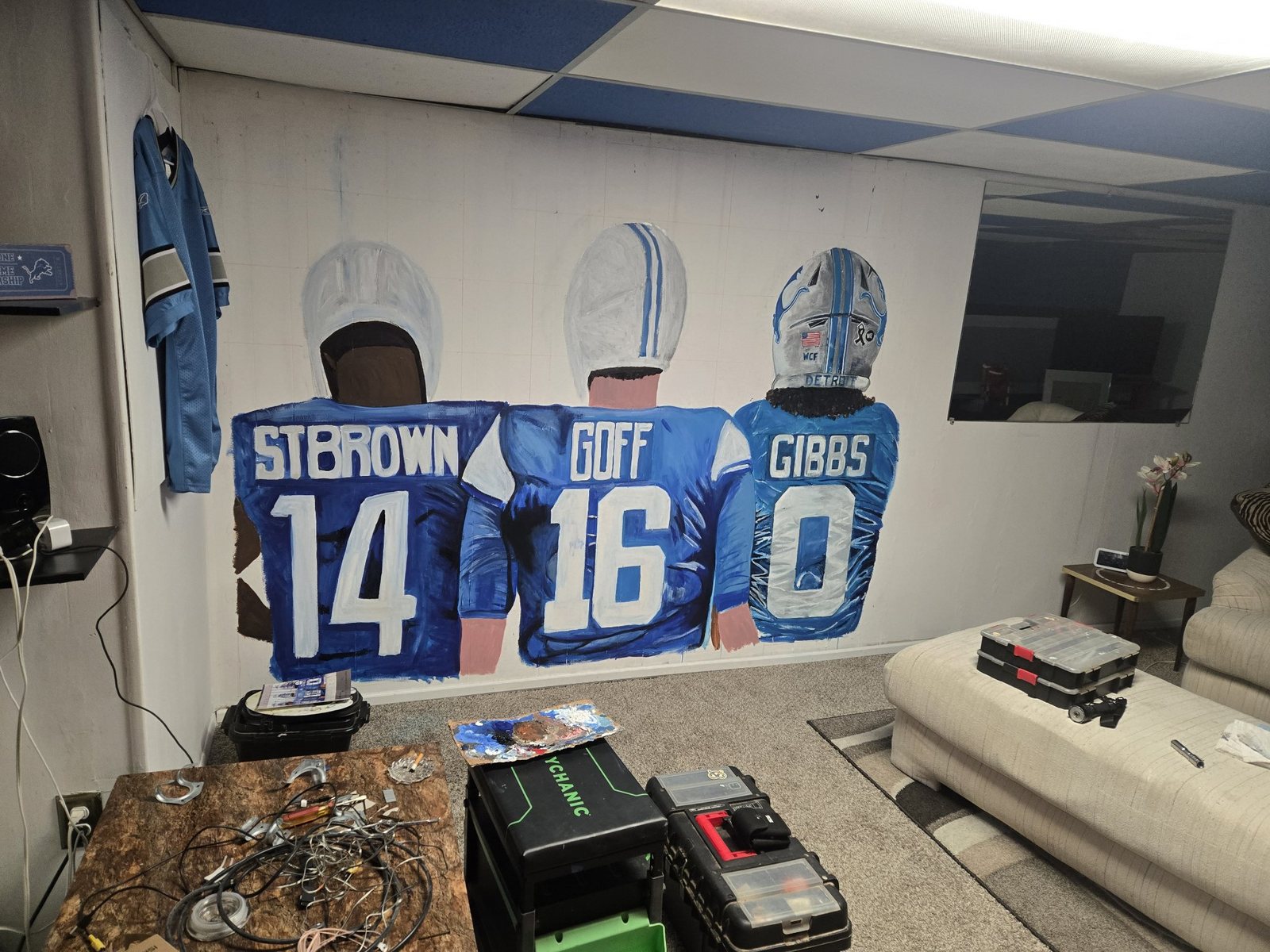 Jeremy Wylie's Detroit Lions mural shown across a large room wall